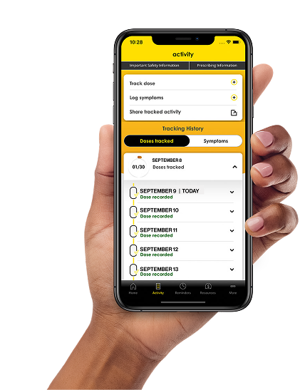 Hand holding a phone that shows a page of the RINVOQ Complete app with a dosing tracker