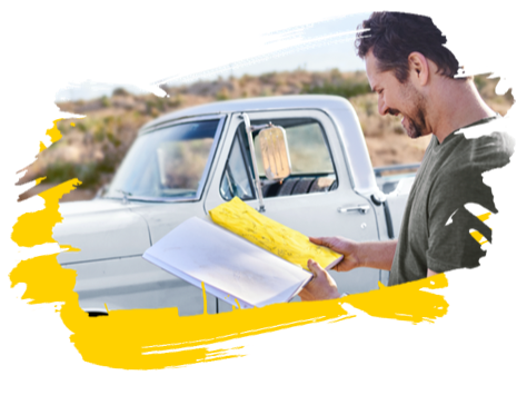 Man reading his map while standing outside next to his car